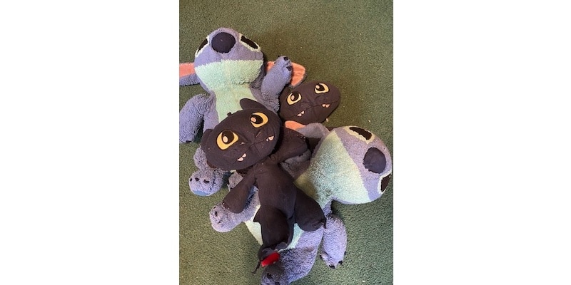 lilo and stitch dolls in a pile on the floor