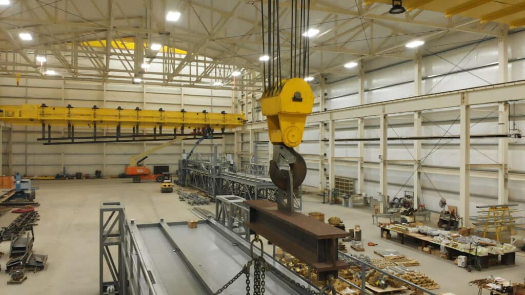 Construction workers working on an overhead crane