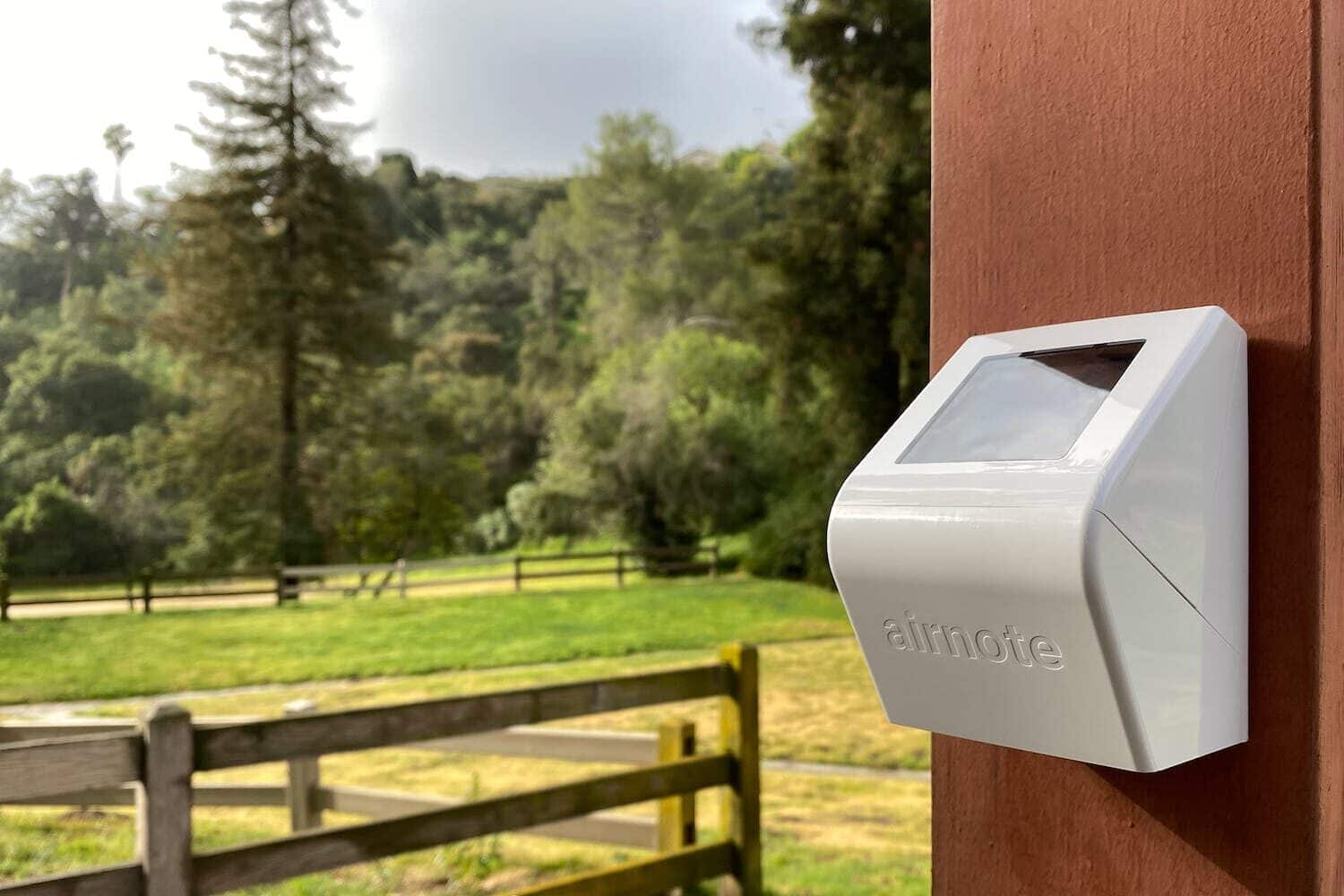 Blues Airnote mounted outside in a field IoT air quality monitoring